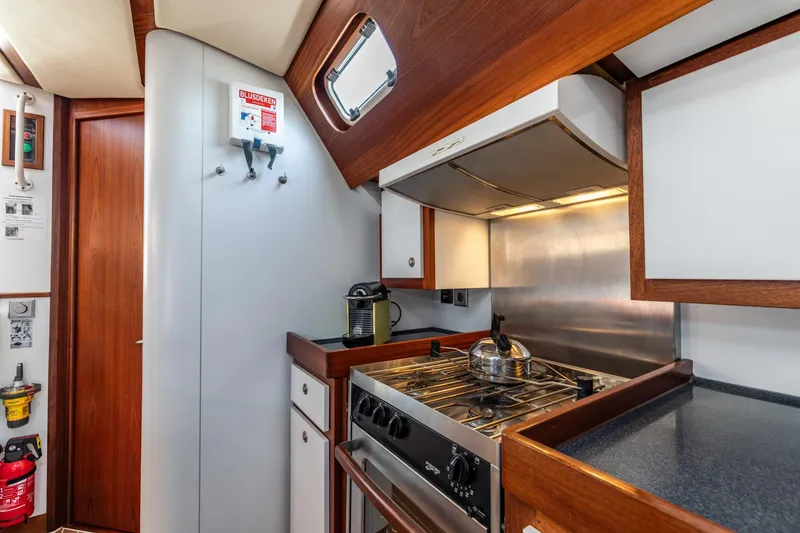 Red Rooster Yacht Photos Pics Galley kitchen in 2008 Van De Stadt Stadtship 70 yacht with stove and kettle.
