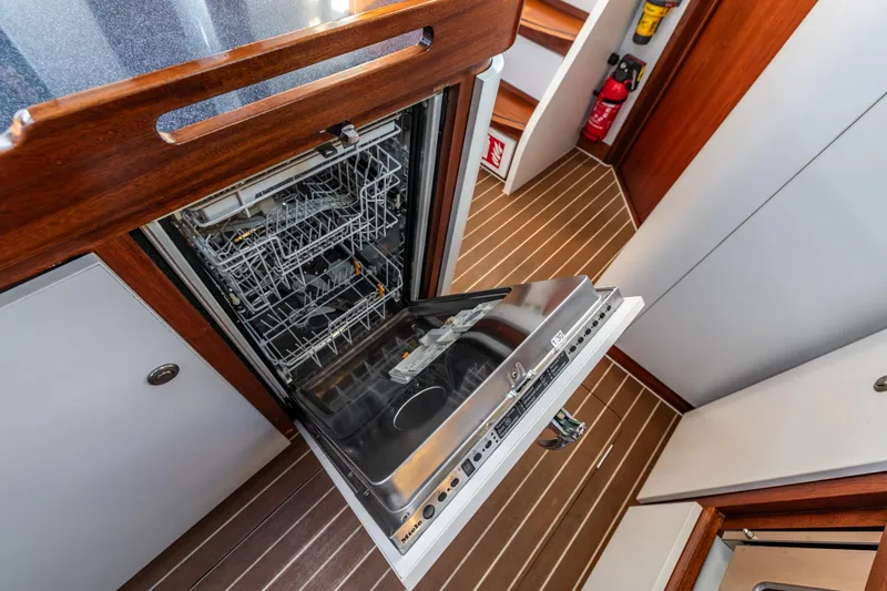 Red Rooster Yacht Photos Pics Open dishwasher in 2008 Van De Stadt Stadtship 70 yacht kitchen interior.