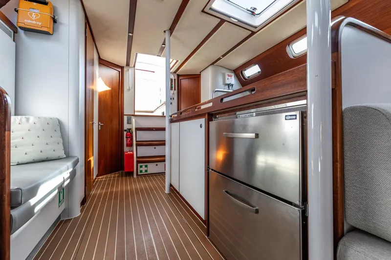 Red Rooster Yacht Photos Pics Interior of 2008 Van De Stadt Stadtship 70 yacht, featuring modern kitchen and seating area.