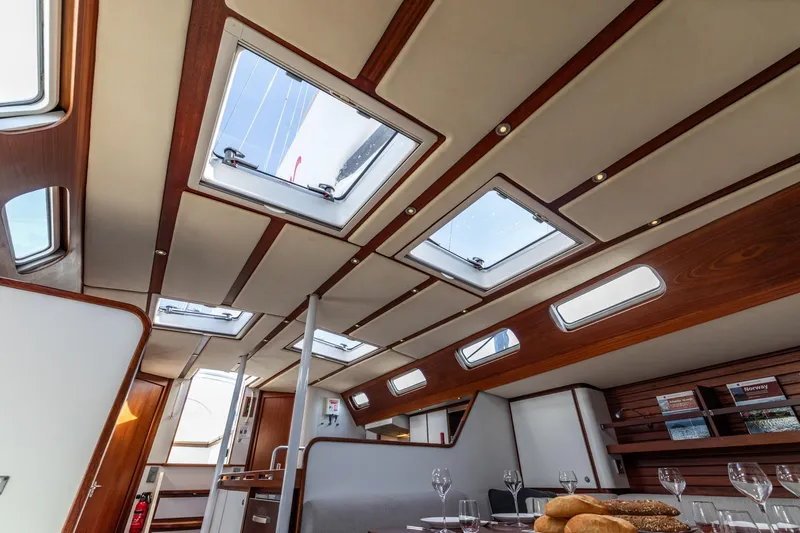 Red Rooster Yacht Photos Pics Interior of 2008 Van De Stadt Stadtship 70 yacht with skylights and dining area.