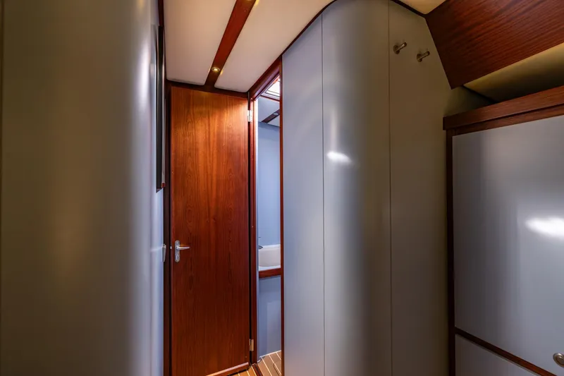Red Rooster Yacht Photos Pics Interior of 2008 Van De Stadt Stadtship 70 yacht, featuring sleek wooden door and modern design.