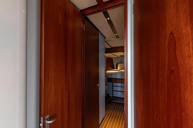 Red Rooster Yacht Photos Pics Interior view of 2008 Van De Stadt Stadtship 70 yacht cabin with wooden doors.
