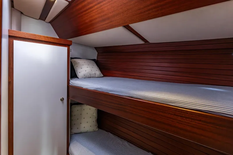 Red Rooster Yacht Photos Pics Interior of 2008 Van De Stadt Stadtship 70 with wooden bunk beds and pillows.