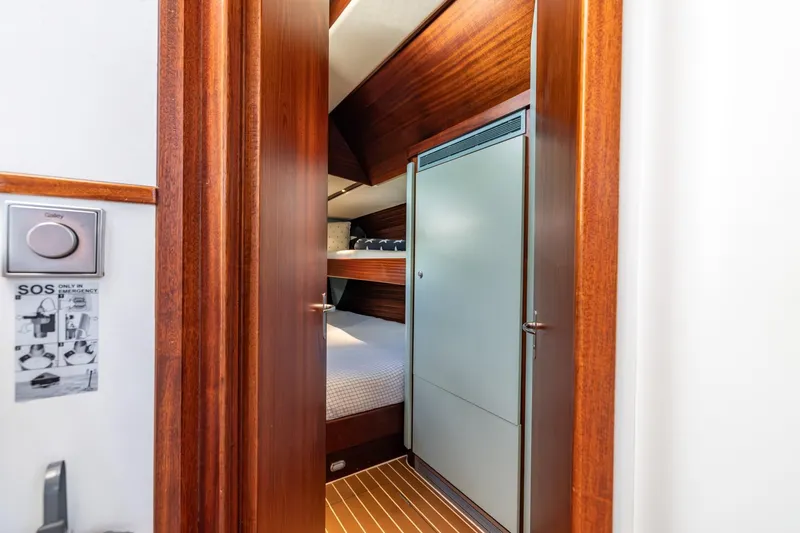 Red Rooster Yacht Photos Pics Interior of 2008 Van De Stadt Stadtship 70 yacht with wooden finishes and bunk beds.