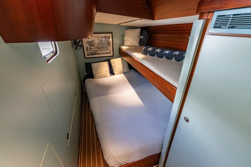 Red Rooster Yacht Photos Pics Cozy cabin interior of 2008 Van De Stadt Stadtship 70 sailboat with wooden accents.