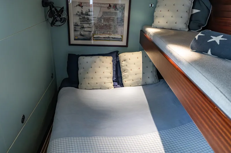 Red Rooster Yacht Photos Pics Cozy cabin interior of 2008 Van De Stadt Stadtship 70 with bunk beds and nautical decor.