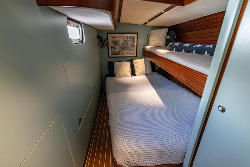Red Rooster Yacht Photos Pics Cozy cabin interior of 2008 Van De Stadt Stadtship 70 with bunk beds and nautical decor.
