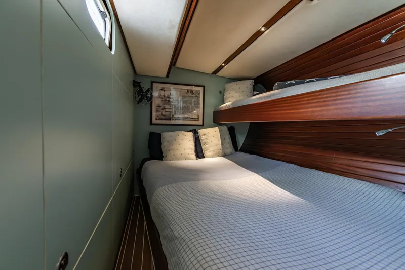 Red Rooster Yacht Photos Pics Cozy cabin interior of 2008 Van De Stadt Stadtship 70 with bunk beds and nautical decor.