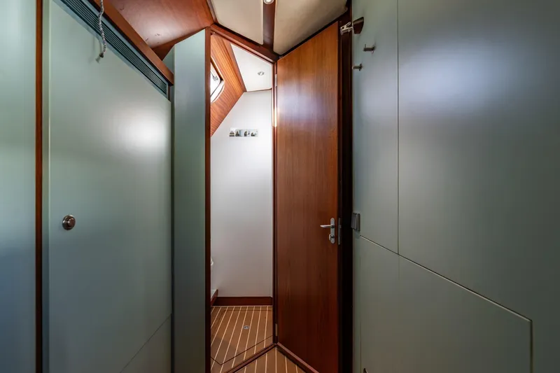 Red Rooster Yacht Photos Pics Interior of 2008 Van De Stadt Stadtship 70 yacht, featuring sleek wooden doors and modern design.