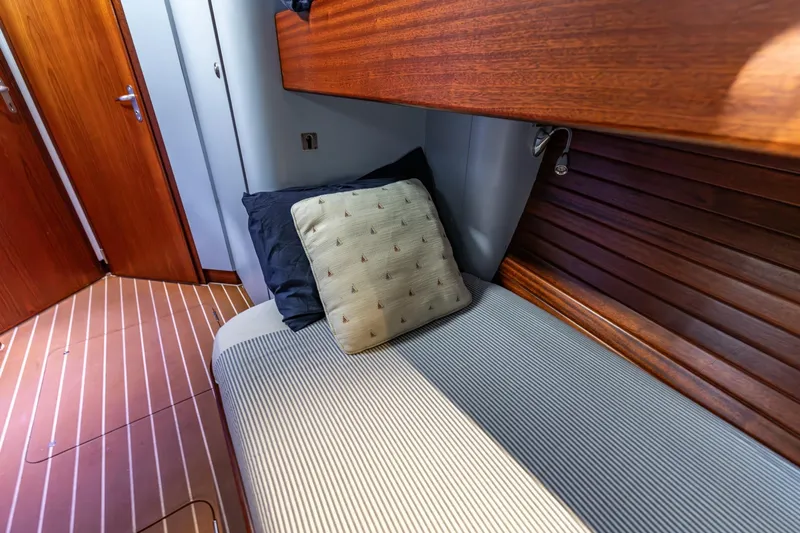 Red Rooster Yacht Photos Pics Cozy cabin interior of 2008 Van De Stadt Stadtship 70 yacht with wooden accents.