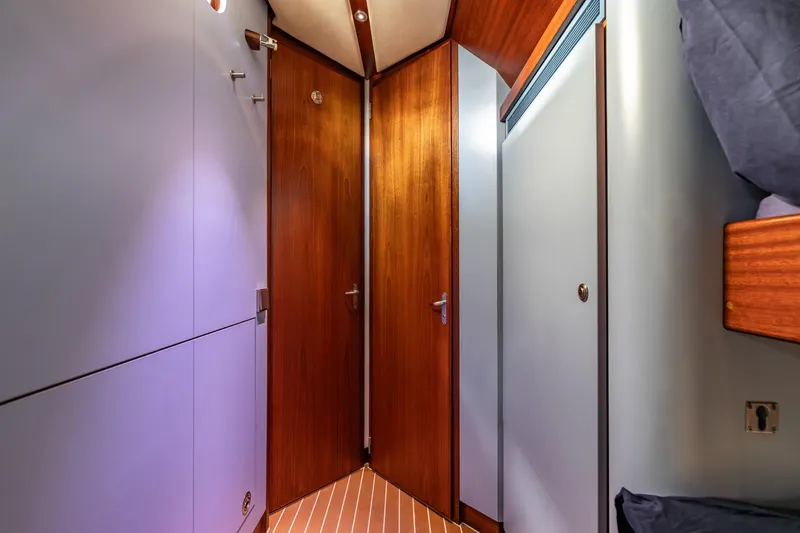 Red Rooster Yacht Photos Pics Interior of 2008 Van De Stadt Stadtship 70 yacht with wooden doors and modern design.
