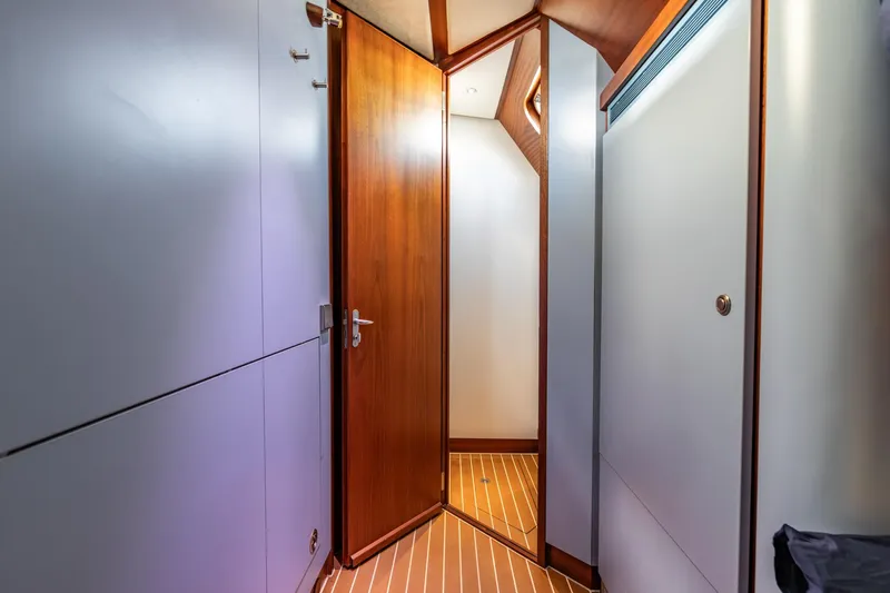 Red Rooster Yacht Photos Pics Interior of 2008 Van De Stadt Stadtship 70 yacht, featuring wooden door and modern design.