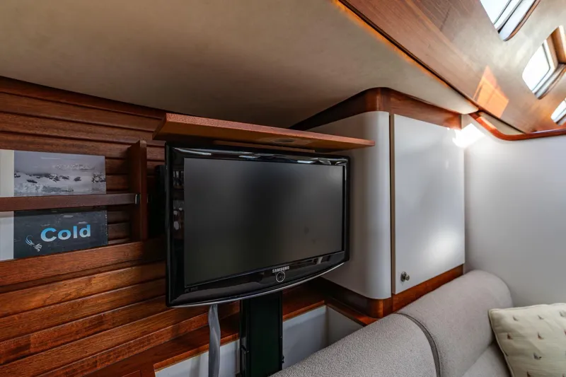 Red Rooster Yacht Photos Pics Interior of 2008 Van De Stadt Stadtship 70 yacht with TV and wooden paneling.