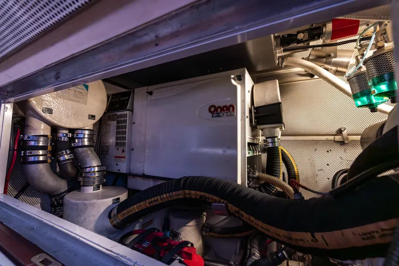 Red Rooster Yacht Photos Pics Engine room of 2008 Van De Stadt Stadtship 70 with Onan generator and complex piping.