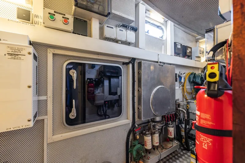 Red Rooster Yacht Photos Pics Engine room of 2008 Van De Stadt Stadtship 70 yacht, featuring control panels and equipment.