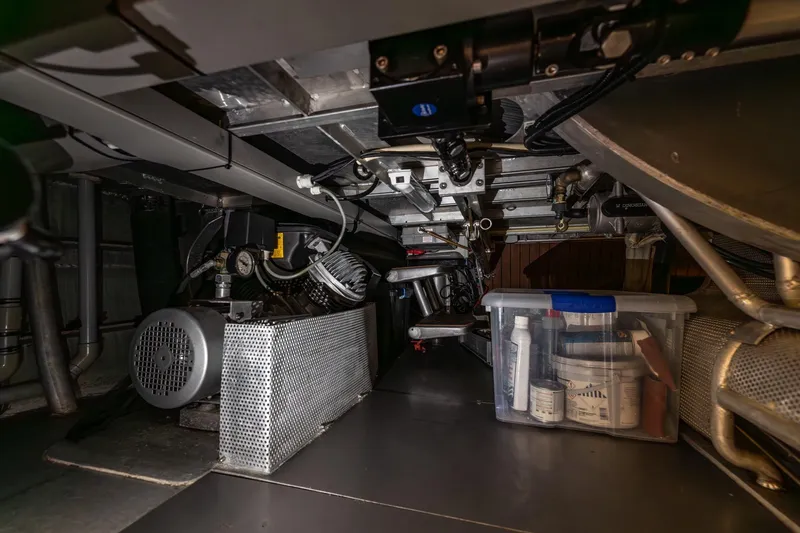Red Rooster Yacht Photos Pics Engine room of 2008 Van De Stadt Stadtship 70 yacht, featuring mechanical components and storage.