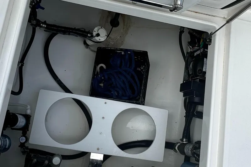  Yacht Photos Pics 2020 Regulator 31 boat storage compartment with hoses and fittings.
