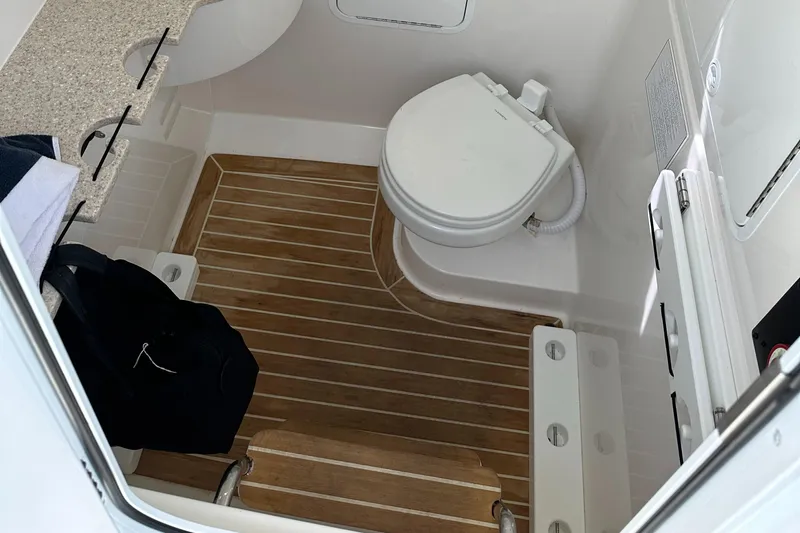  Yacht Photos Pics 2020 Regulator 31 boat interior with toilet and wooden flooring.