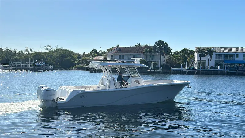 Seakeeper And Joystick Yacht Photos Pics 2020 Sea Fox 368 Commander boat cruising on a sunny day near waterfront homes.