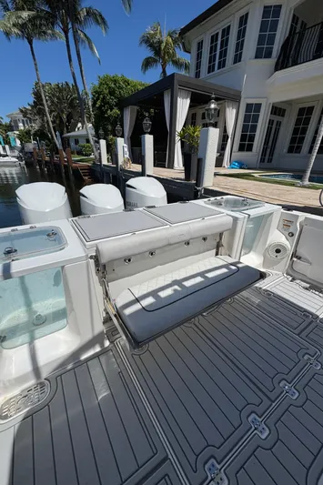 Seakeeper And Joystick Yacht Photos Pics 2020 Sea Fox 368 Commander boat with spacious deck and seating, docked by a waterfront home.