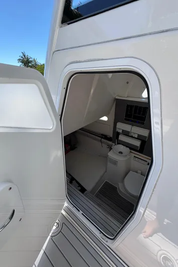 Seakeeper And Joystick Yacht Photos Pics 2020 Sea Fox 368 Commander boat interior with open door, showing compact bathroom facilities.