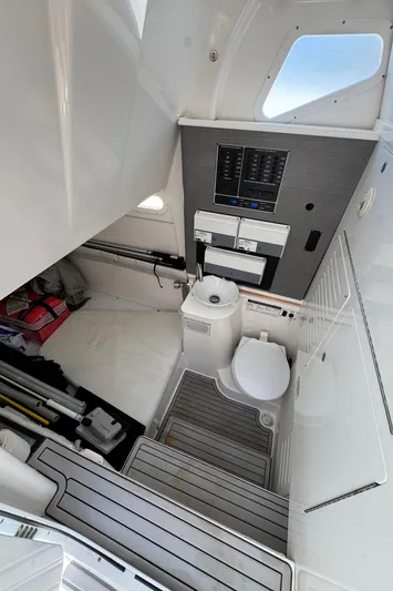 Seakeeper And Joystick Yacht Photos Pics Interior of 2020 Sea Fox 368 Commander boat, featuring a compact marine toilet area.