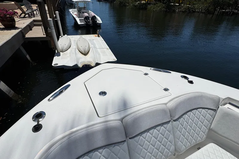 Seakeeper And Joystick Yacht Photos Pics 2020 Sea Fox 368 Commander boat docked, featuring cushioned seating and watercraft in the background.