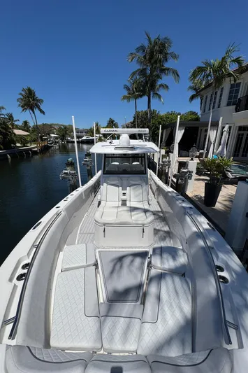 Seakeeper And Joystick Yacht Photos Pics 2020 Sea Fox 368 Commander boat docked by a canal with palm trees.