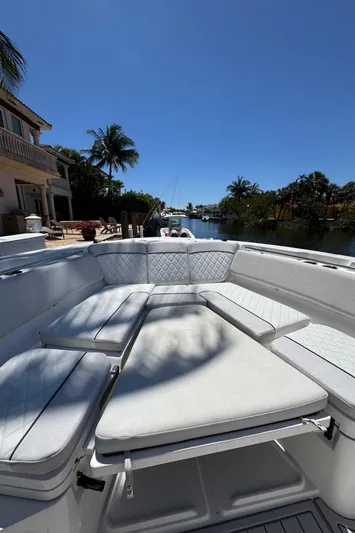 Seakeeper And Joystick Yacht Photos Pics 2020 Sea Fox 368 Commander boat with spacious seating, docked near waterfront homes.