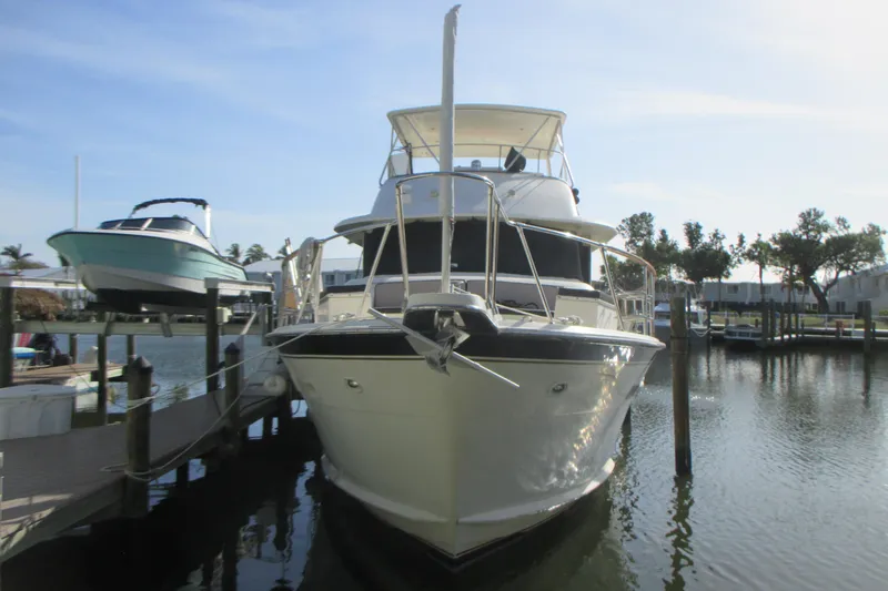 Hattitude Yacht Photos Pics 1981 Hatteras 61 Motor Yacht docked in a marina, front view.