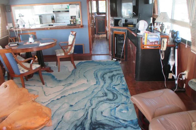 Hattitude Yacht Photos Pics Interior of 1981 Hatteras 61 Motor Yacht with elegant decor and blue patterned rug.