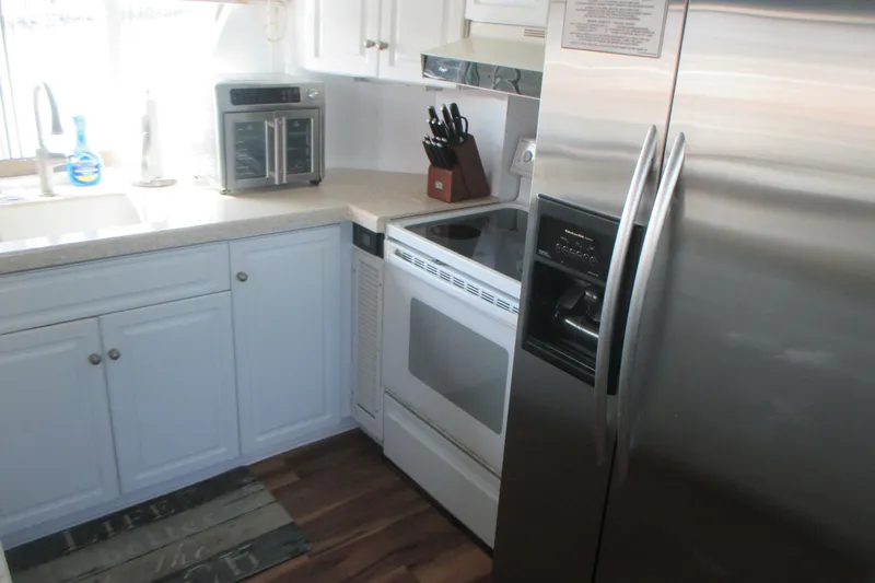 Hattitude Yacht Photos Pics Modern kitchen inside 1981 Hatteras 61 Motor Yacht with stainless steel appliances.