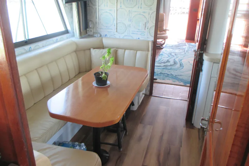 Hattitude Yacht Photos Pics Interior of 1981 Hatteras 61 Motor Yacht with dining area and potted plant.