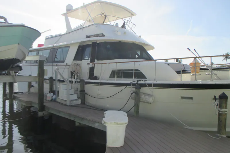 Hattitude Yacht Photos Pics 1981 Hatteras 61 Motor Yacht docked at marina, side view.