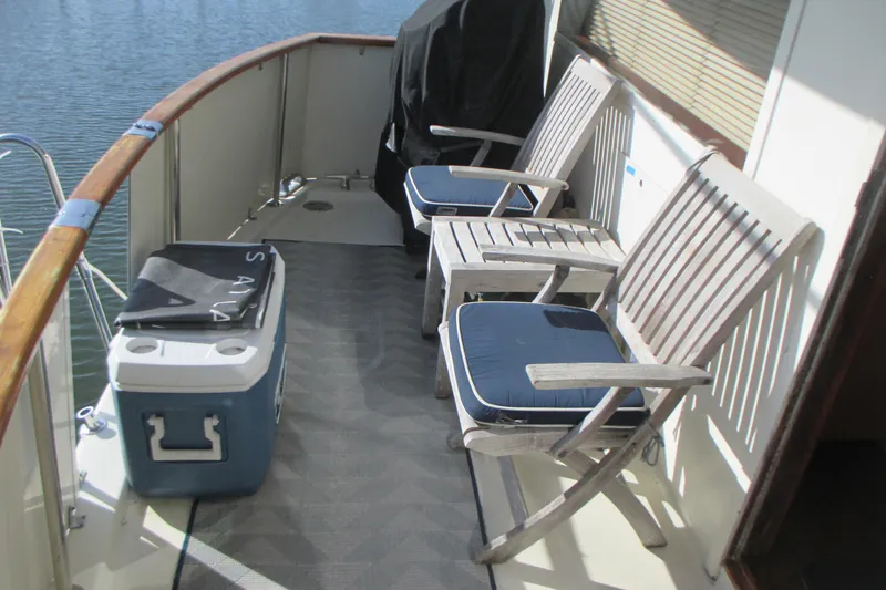 Hattitude Yacht Photos Pics Outdoor seating area on 1981 Hatteras 61 Motor Yacht with chairs and cooler.