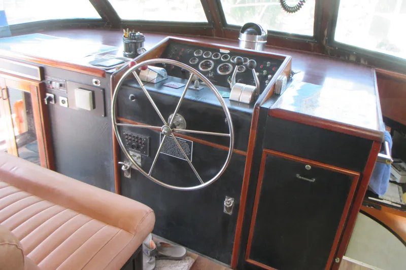 Hattitude Yacht Photos Pics 1981 Hatteras 61 Motor Yacht helm with classic steering wheel and control panel.