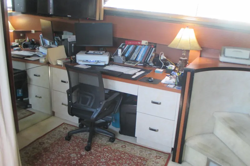 Hattitude Yacht Photos Pics Office space inside a 1981 Hatteras 61 Motor Yacht with desk, chair, and lamp.