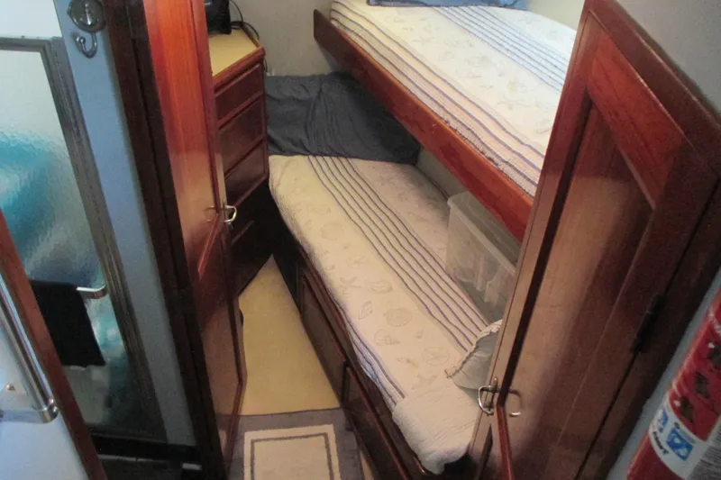 Hattitude Yacht Photos Pics Cozy cabin with bunk beds on 1981 Hatteras 61 Motor Yacht.