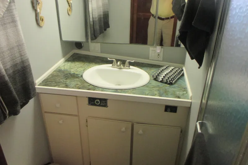 Hattitude Yacht Photos Pics Bathroom vanity on 1981 Hatteras 61 Motor Yacht with sink and mirror.