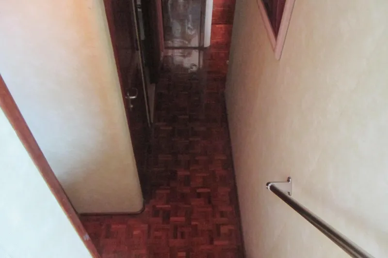 Hattitude Yacht Photos Pics Narrow hallway with wooden flooring inside 1981 Hatteras 61 Motor Yacht.