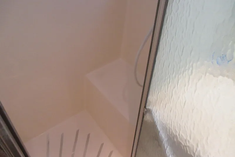 Hattitude Yacht Photos Pics Shower area inside 1981 Hatteras 61 Motor Yacht with frosted glass door.