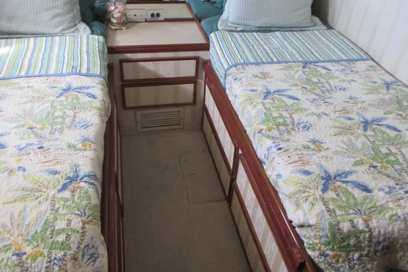 Hattitude Yacht Photos Pics Interior of 1981 Hatteras 61 Motor Yacht with twin beds and floral bedding.