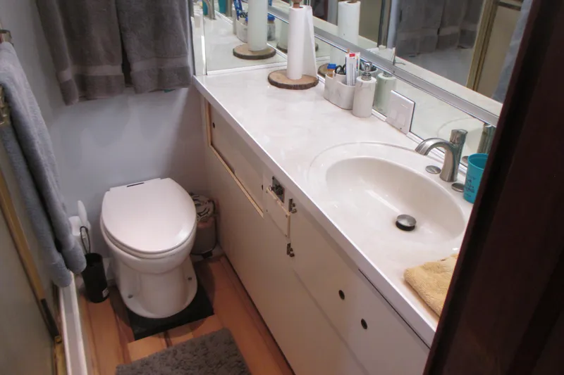 Hattitude Yacht Photos Pics Bathroom interior of 1981 Hatteras 61 Motor Yacht with sink and toilet.