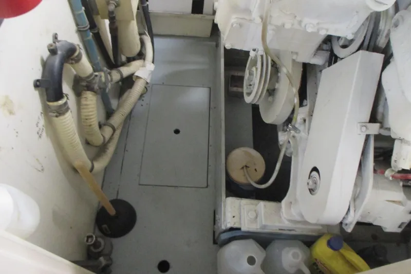 Hattitude Yacht Photos Pics Engine room of 1981 Hatteras 61 Motor Yacht with visible pipes and machinery.