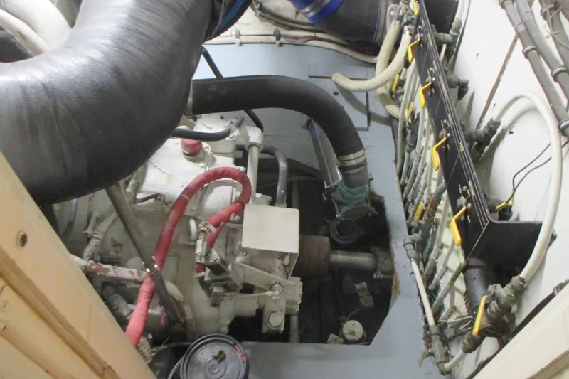 Hattitude Yacht Photos Pics Engine room of 1981 Hatteras 61 Motor Yacht, showing mechanical components and piping.