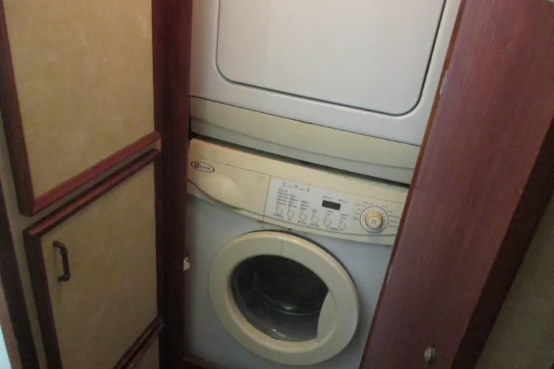 Hattitude Yacht Photos Pics Stacked washer and dryer in 1981 Hatteras 61 Motor Yacht laundry area.