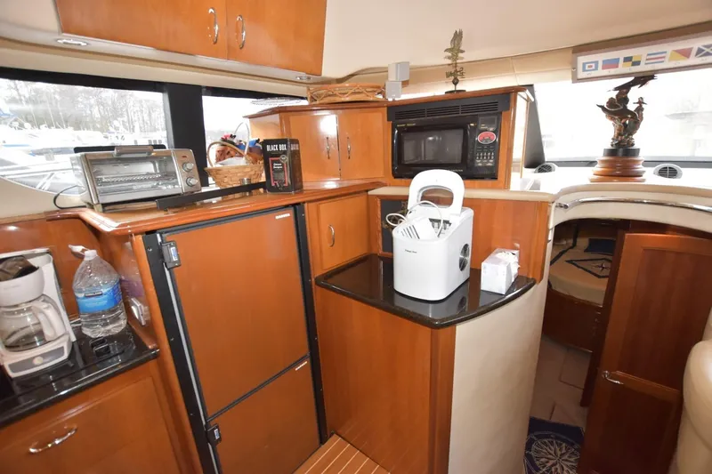 E2rt Yacht Photos Pics Interior of 2006 Carver 46 Voyager yacht kitchen with appliances and wooden cabinetry.