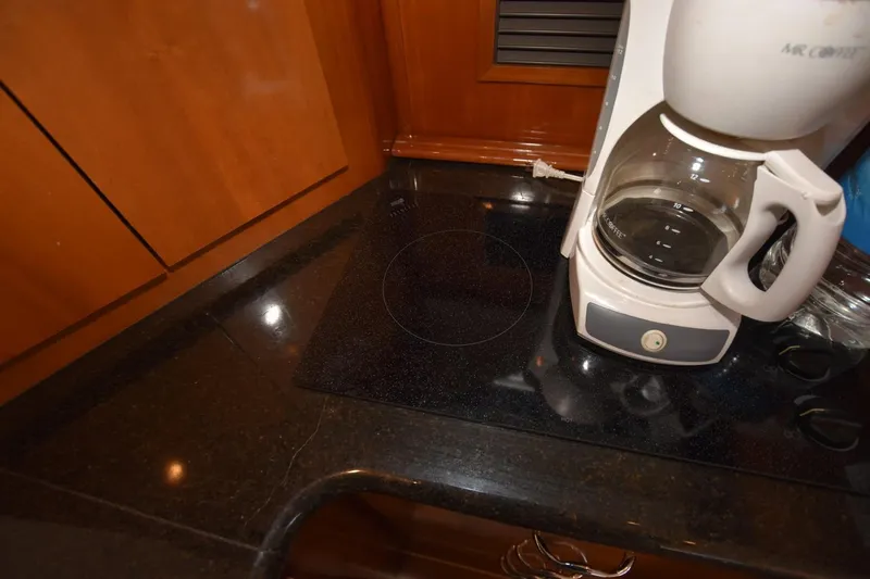 E2rt Yacht Photos Pics Coffee maker on black countertop in 2006 Carver 46 Voyager kitchen.