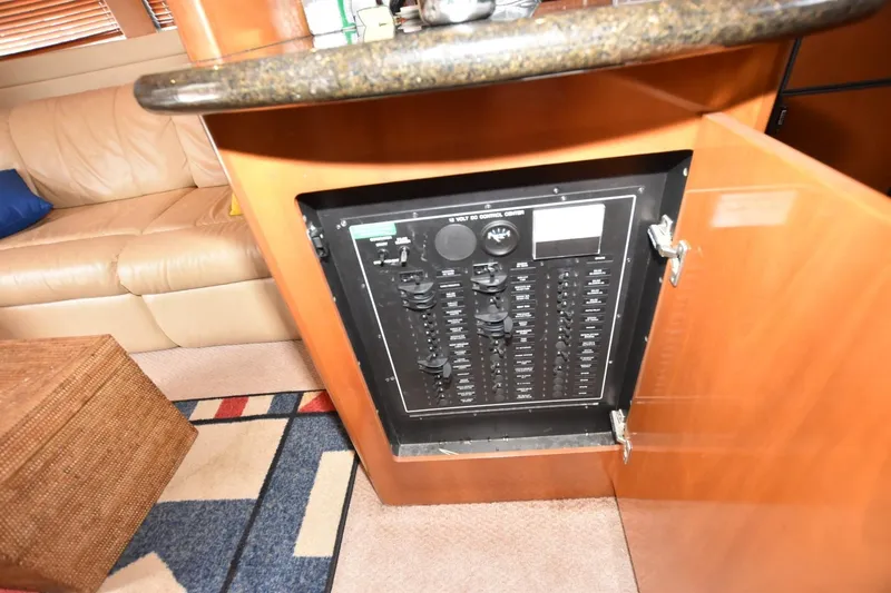 E2rt Yacht Photos Pics Electrical panel inside 2006 Carver 46 Voyager yacht, with open cabinet and cozy interior.