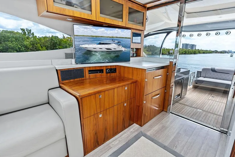 Seas The Moment Yacht Photos Pics Interior of 2022 Riviera 6000 Sport Yacht with modern wood cabinetry and sleek design.